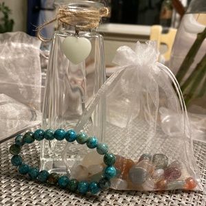 Small vase with crystals and a bracelet